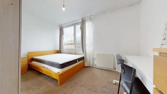 Bright and airy master bedroom featuring a larg...
