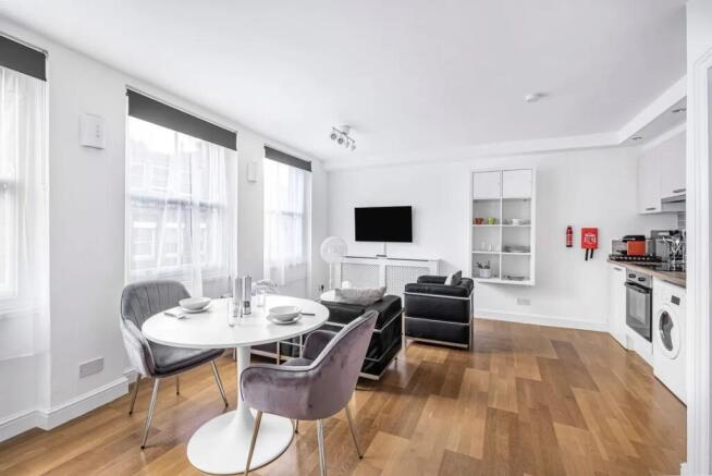 Bright and modern living room featuring large w...