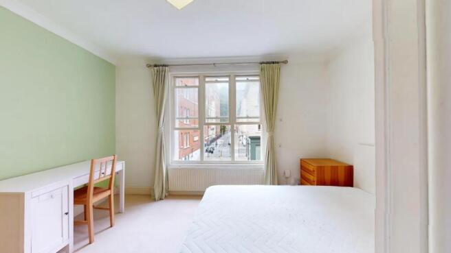 Bright and airy double bedroom featuring a larg...