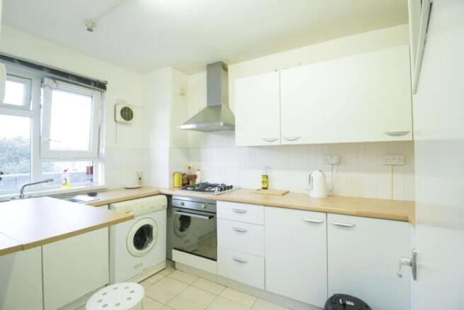 Bright and tidy kitchen featuring ample counter...