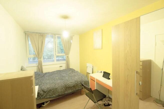Bright and cozy double bedroom featuring a comf...