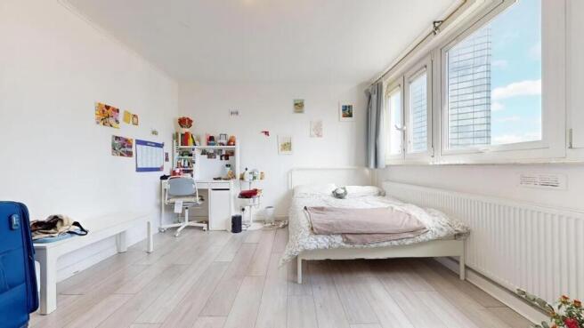 Bright and airy master bedroom featuring a comf...
