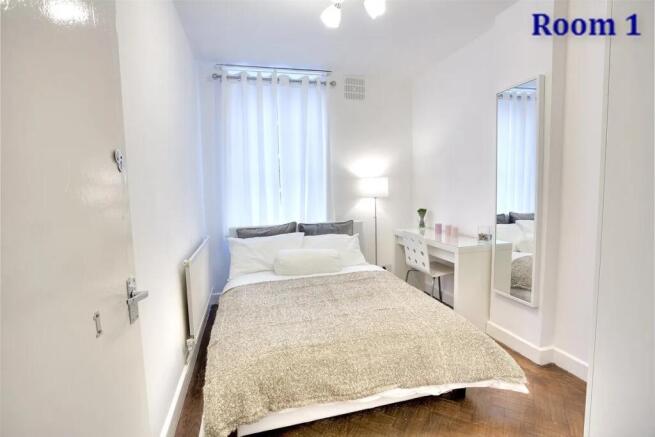 A bright and clean double bedroom featuring a c...