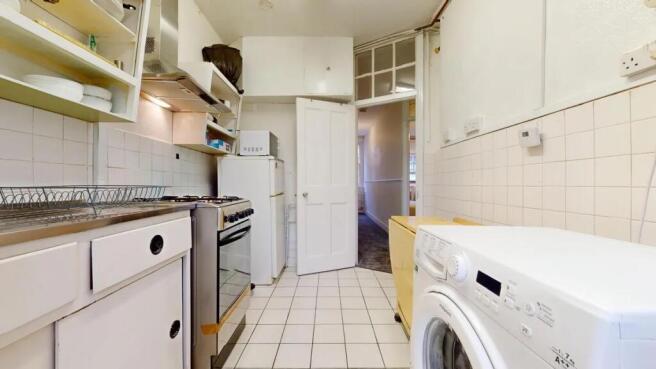 A clean and functional kitchen featuring white ...
