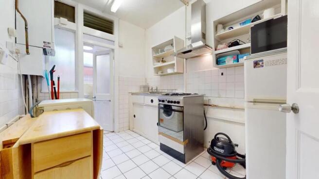 Bright and functional kitchen with white tiled ...