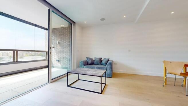 A modern living room with a sleek blue sofa and...