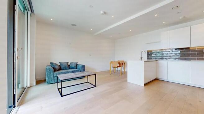 Bright and modern living space featuring a comf...
