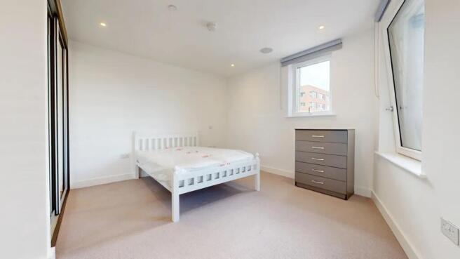 A bright and tidy double bedroom featuring a wh...