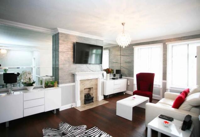 A stylish living room featuring a white leather...