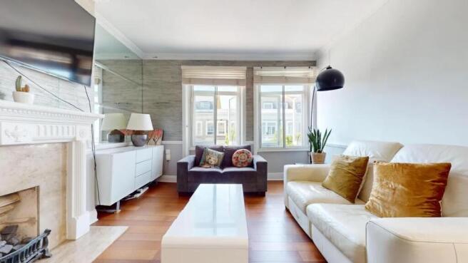 A bright and contemporary living room featuring...