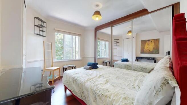 Bright and spacious master bedroom featuring a ...