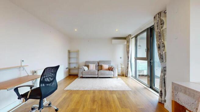 A bright and modern living room featuring woode...