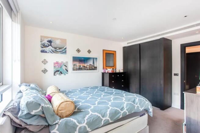 Bright and spacious master bedroom featuring a ...
