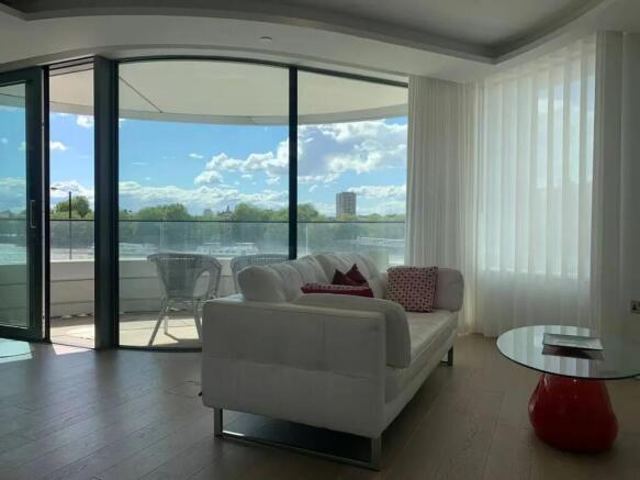Bright and modern living room featuring a styli...