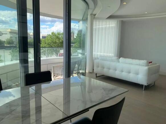 A modern living room featuring a sleek white so...