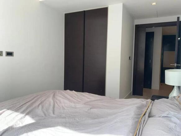 A clean and bright double bedroom featuring a l...