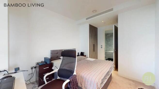 A modern master bedroom featuring a comfortable...