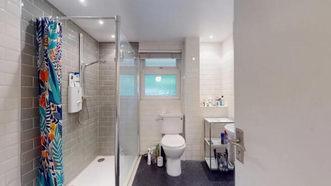 Bright and modern bathroom suite featuring a wa...