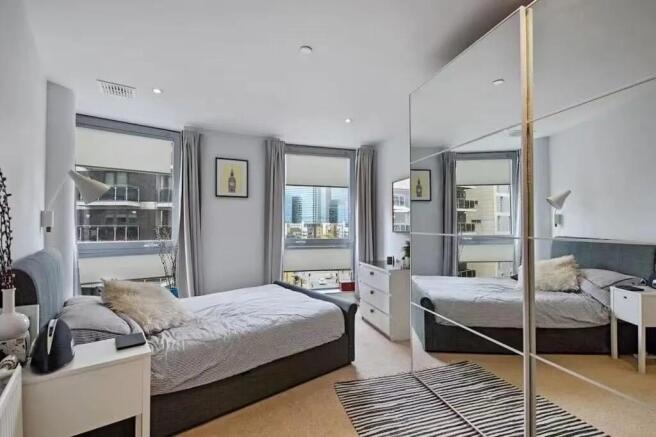 Bright and modern double bedroom featuring larg...