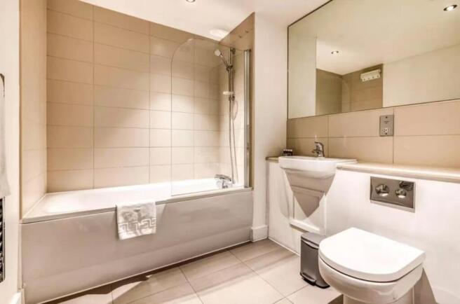 A modern and clean bathroom suite featuring a l...