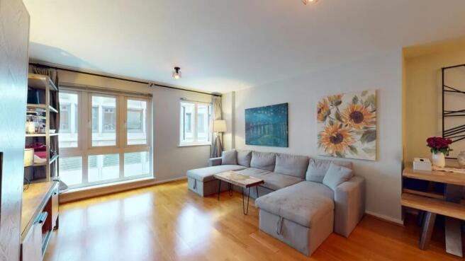 Bright and inviting living room with ample natu...