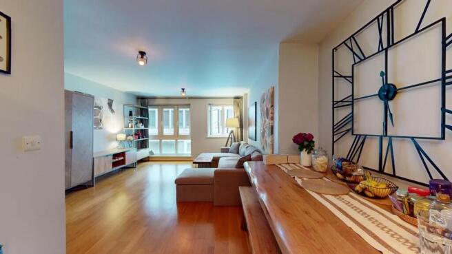 Bright and spacious living room featuring warm ...