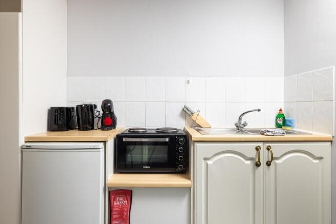 A tidy and well-equipped kitchenette perfect fo...