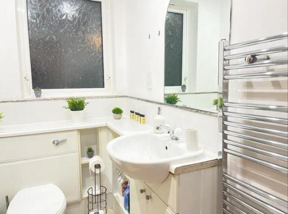A bright and modern bathroom featuring sleek fi...
