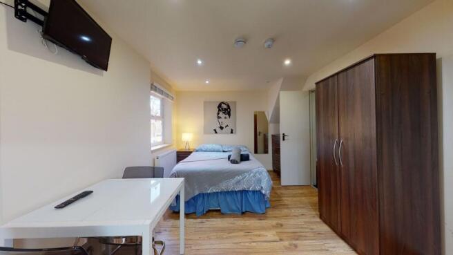 A bright and tidy double bedroom featuring a co...