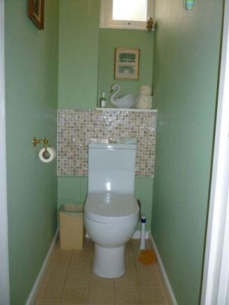 A clean and neatly maintained single toilet roo...