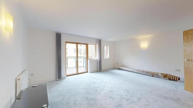 Bright and spacious living room with large wind...
