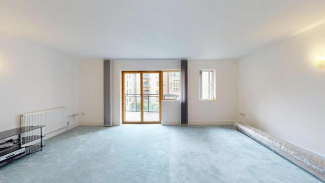 Bright and spacious living room with large wind...