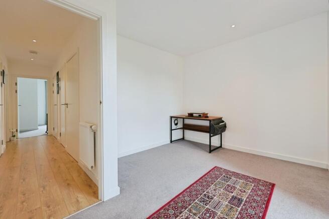 Bright and spacious master bedroom with white w...
