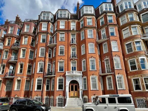 A striking red-brick terraced house with elegan...