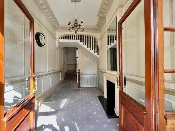 Bright and elegant hallway featuring classic de...