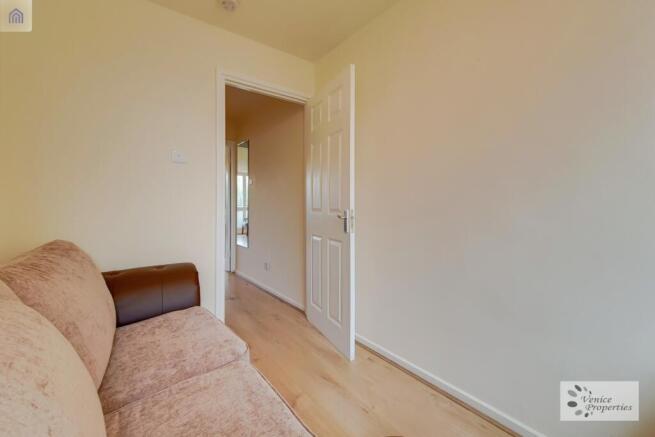 A bright and tidy living room with a comfortabl...