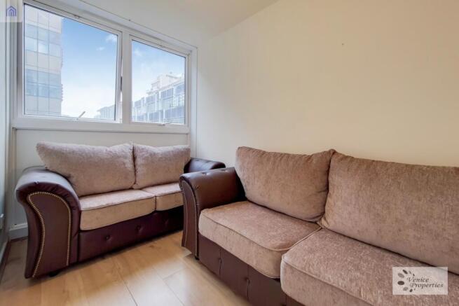 A bright and inviting living room featuring two...