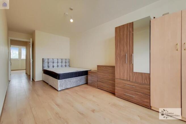 A well-lit, tidy single bedroom featuring a com...