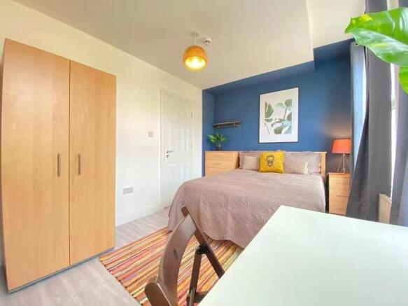 Bright and welcoming master bedroom featuring a...