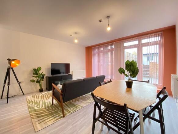 Bright and modern living room featuring a comfo...