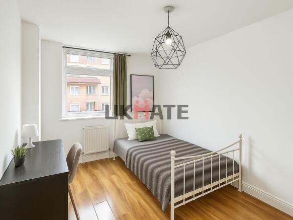 Bright and inviting double bedroom with a large...