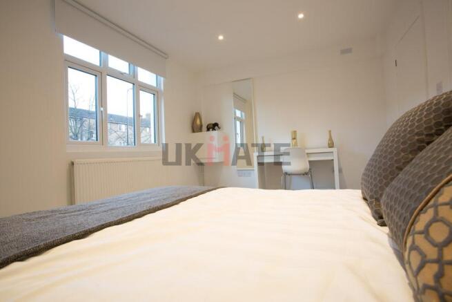 Bright and airy bedroom with large windows prov...