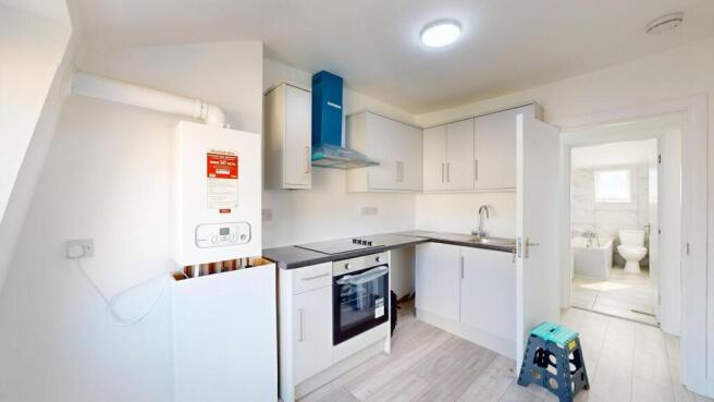 Bright, modern kitchen with white cabinetry, a ...