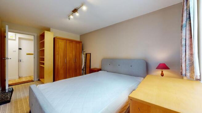 A bright and inviting double bedroom featuring ...