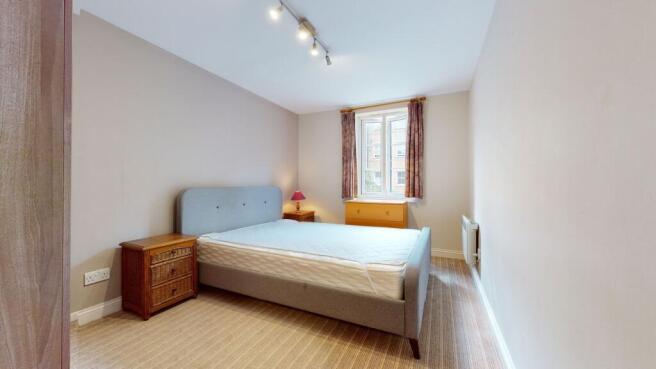 A well-maintained spacious double bedroom featu...