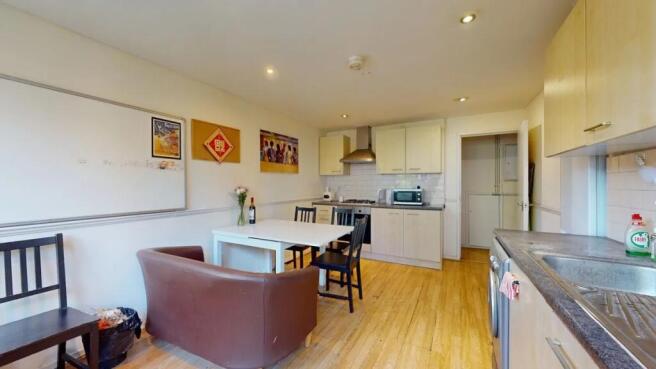 Bright and tidy kitchen featuring modern applia...