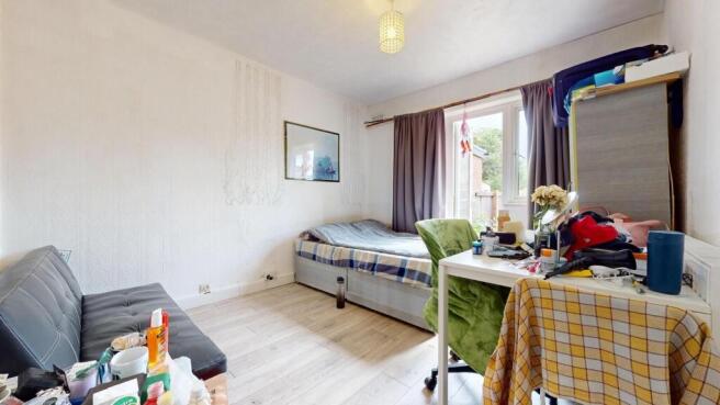 A compact and functional student bedroom featur...