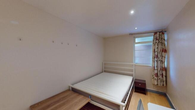 A bright and simple double bedroom featuring a ...