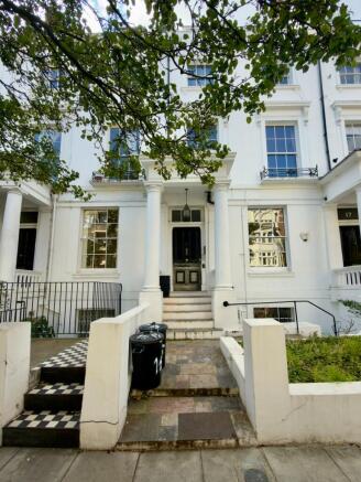 A charming white-fronted building with elegant ...