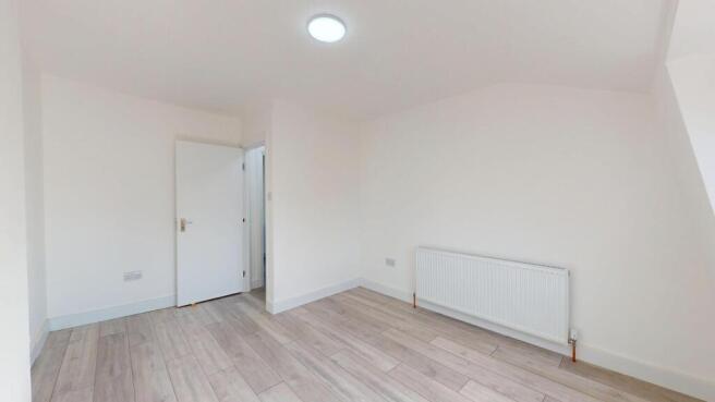 Bright, freshly painted bedroom with neutral fl...